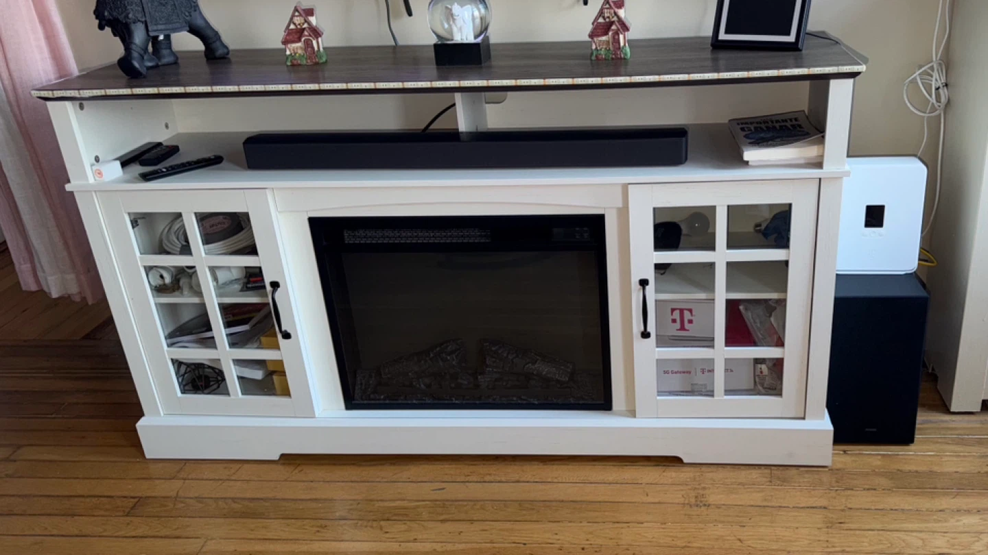 White shelf with electric fireplace.