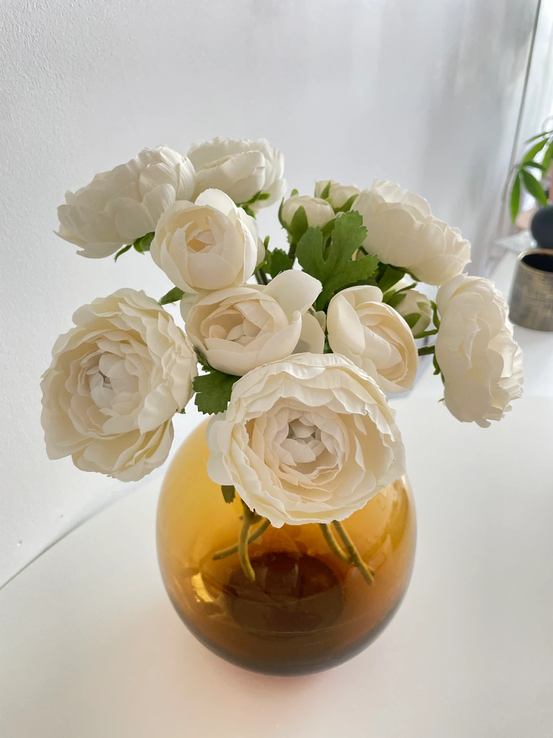 Faux White Ranunculus Flowers in Amber Glass Vase