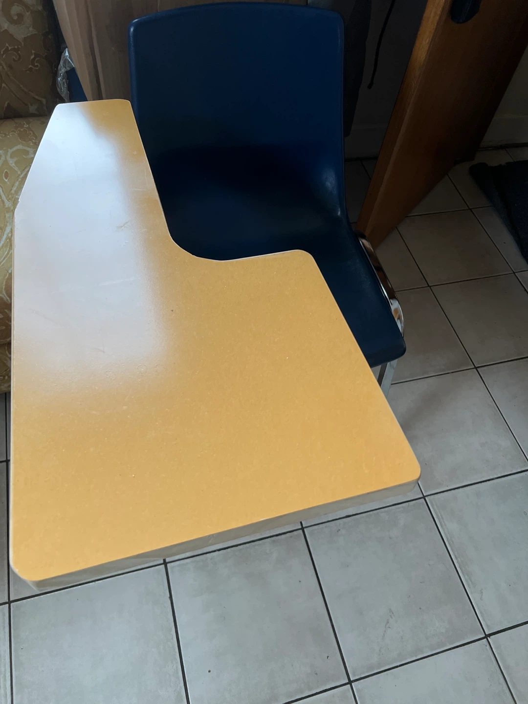 Blue student chair with attached writing tablet