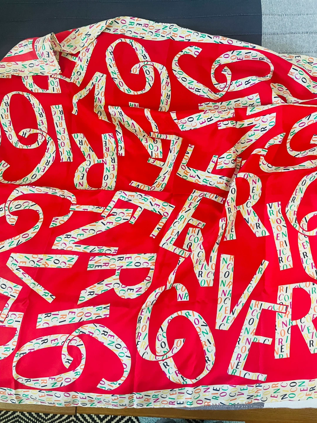 Red scarf with colorful letters pattern
