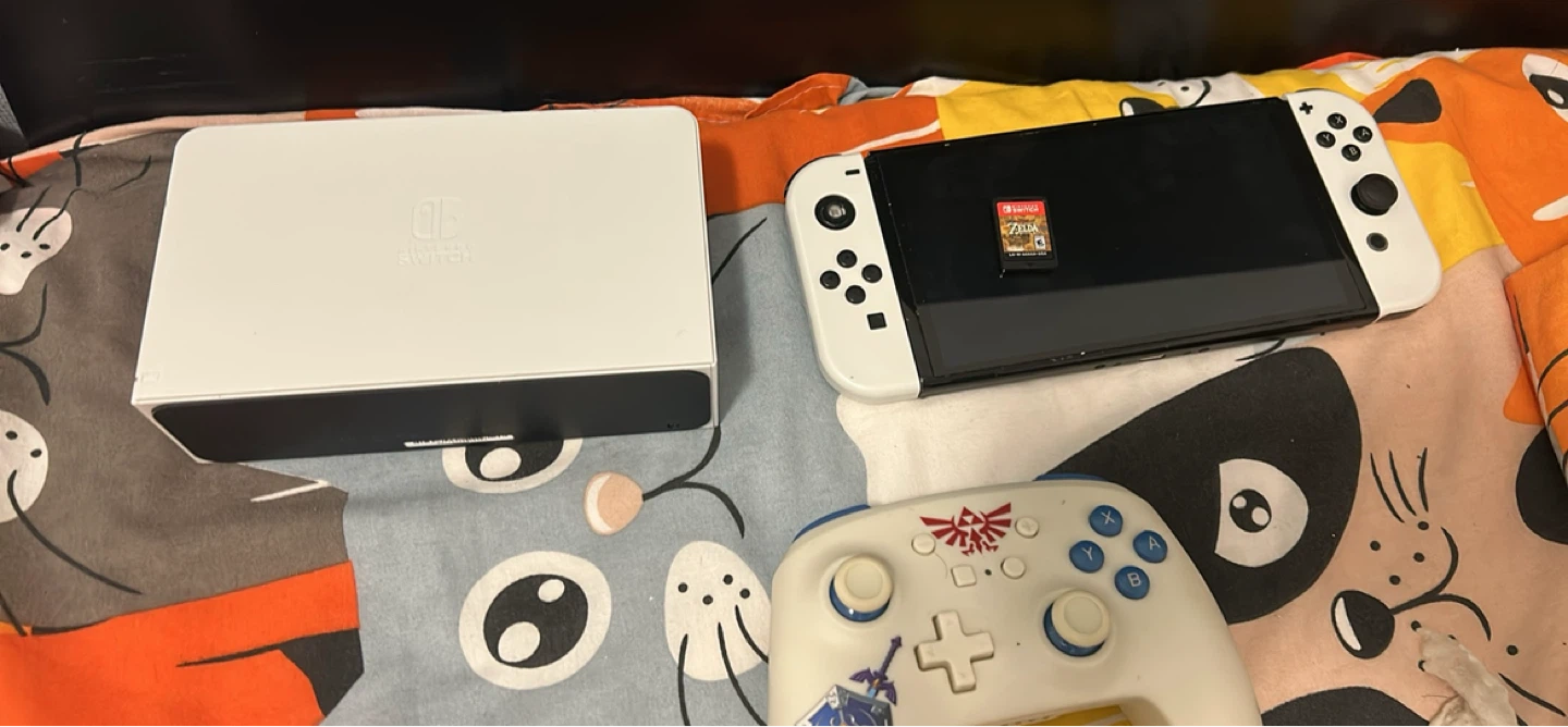 Nintendo switch oled in with with zelda and power a controller