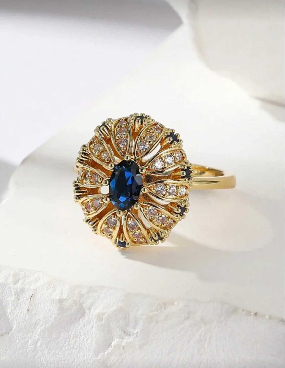 Gold-tone Ring with Blue Oval Stone and Clear Accent Stones