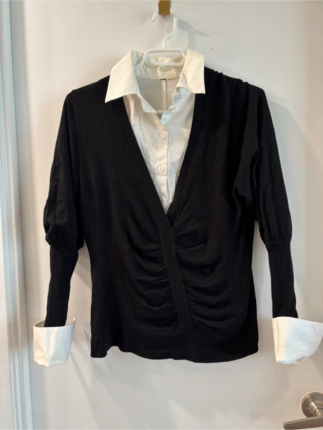 Black ruched V-neck sweater with white cuffs