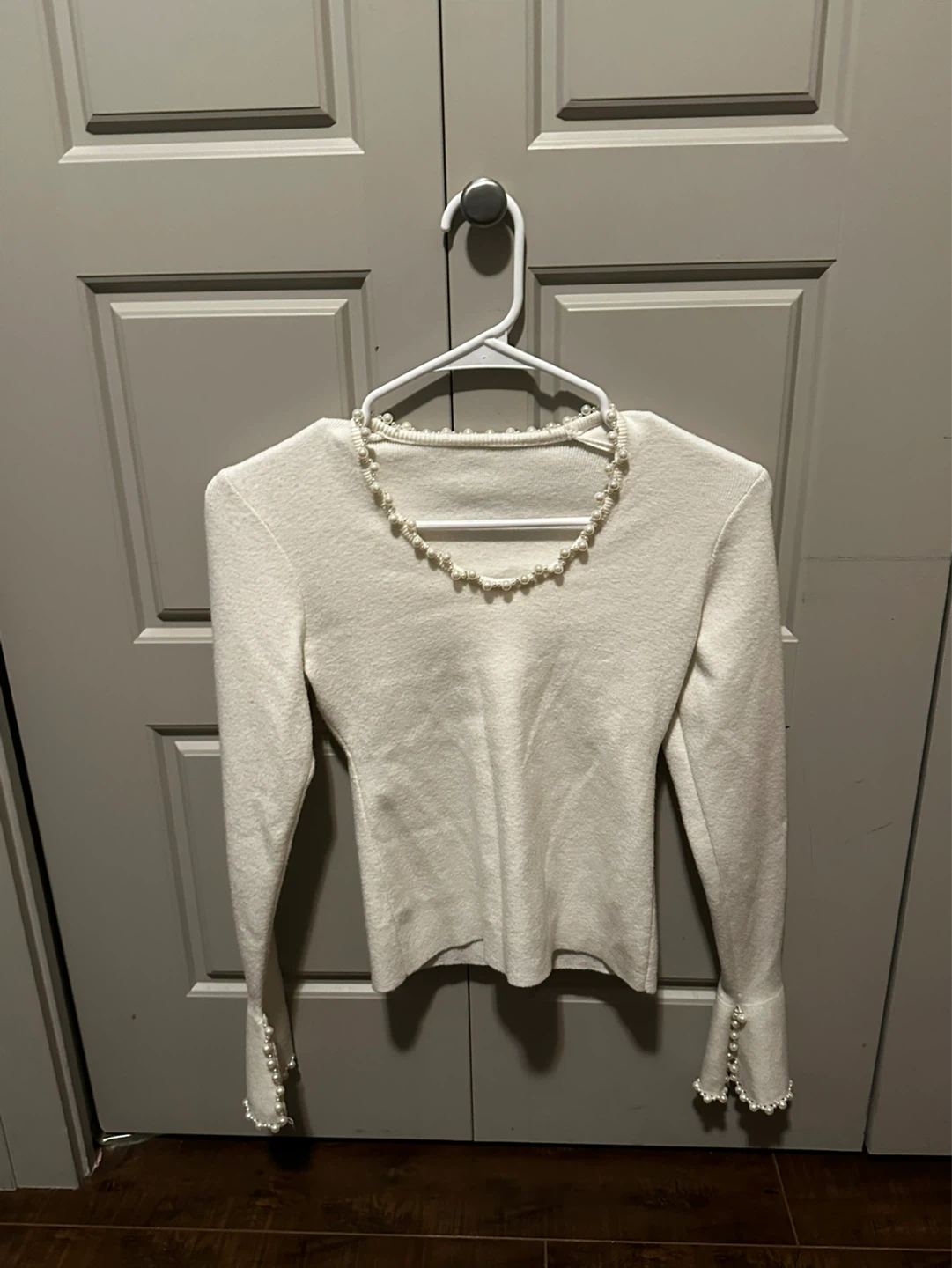 White pearl-embellished sweater and grey shorts set