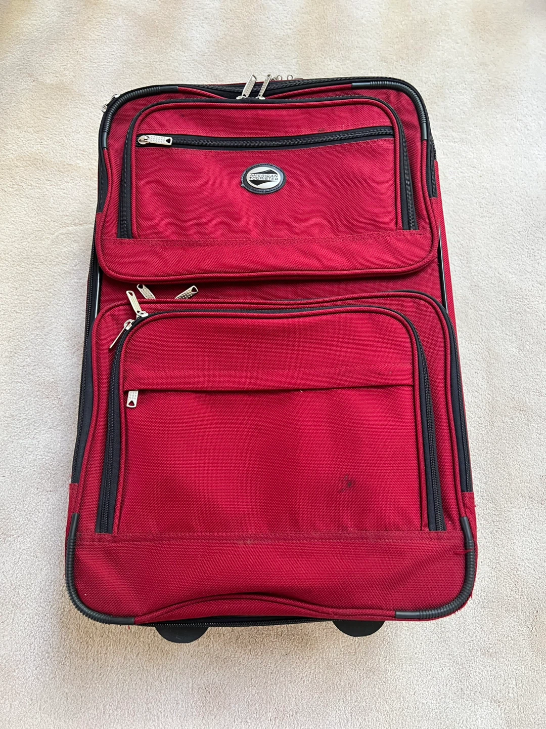 Red American Tourister Rolling Suitcase, 24”x16”x9”