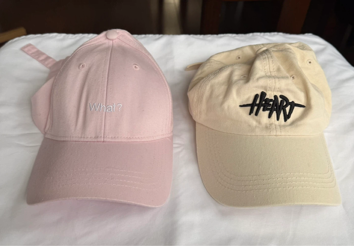 Two baseball caps - pink and beige