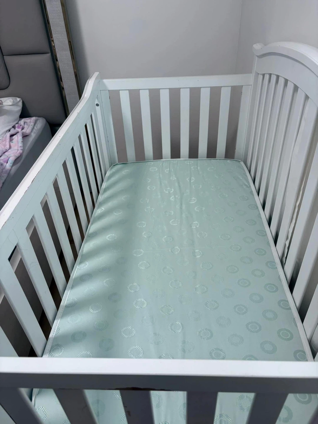 White Baby Crib with Pink Fitted Sheet