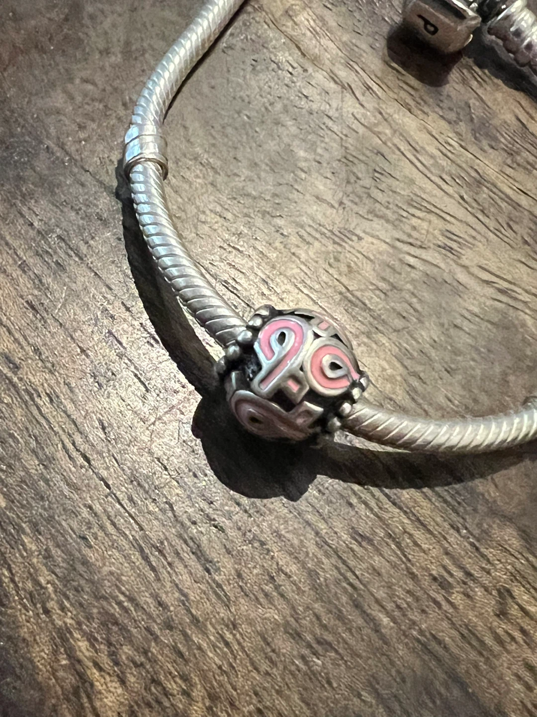 Retired Pandora breast cancer awareness charm