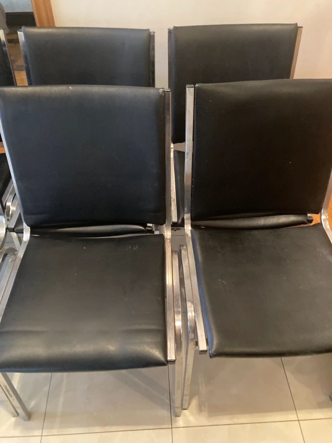 10 stackable chairs with black padded seats and backs. - photo 2