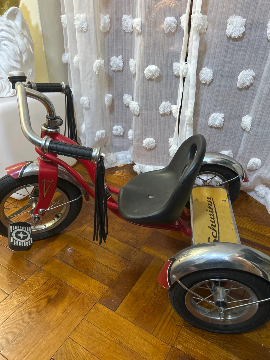 Red Schwinn Tricycle with Black Seat and Tassels