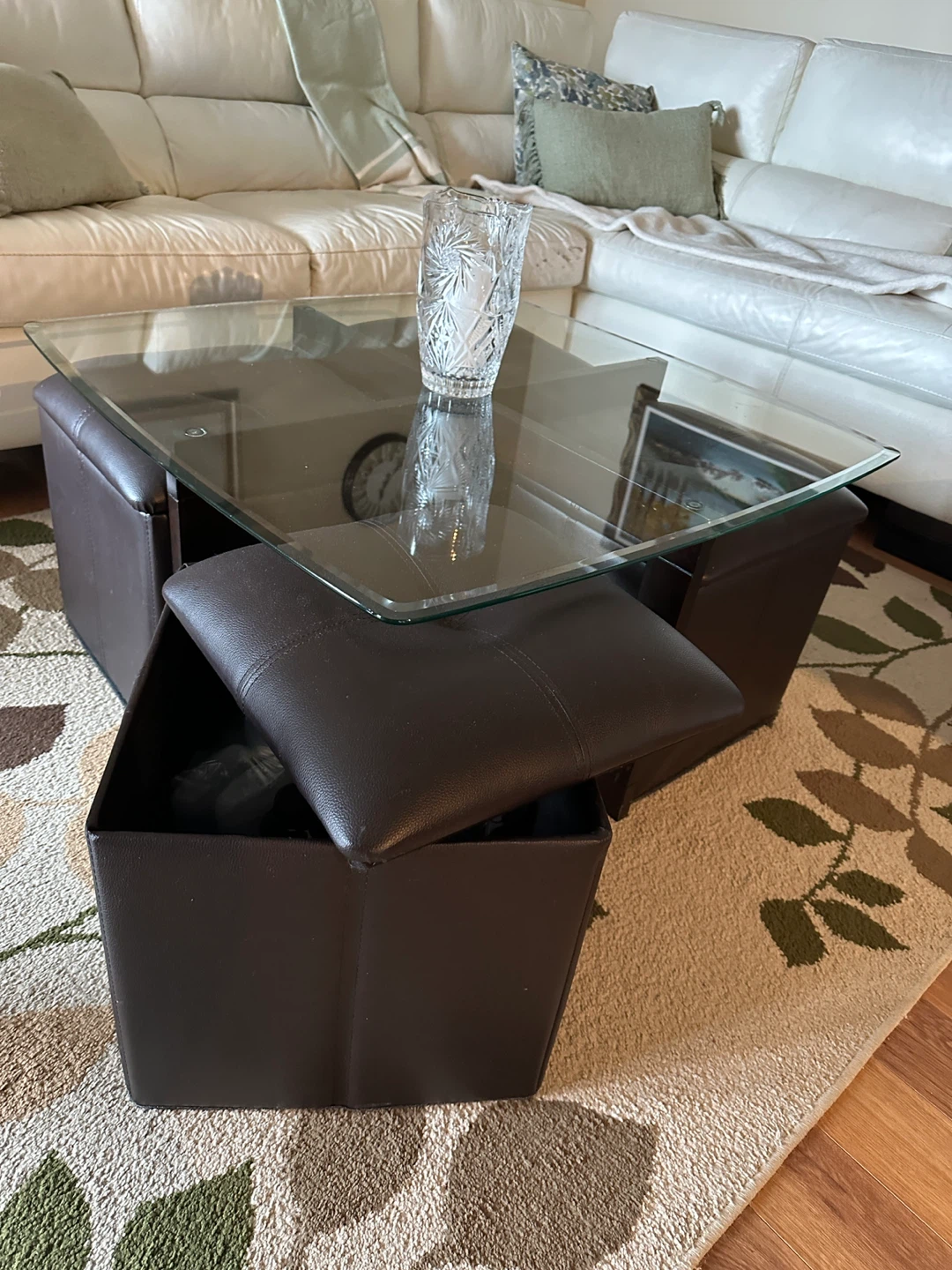 Glass top coffee table with storage ottomans