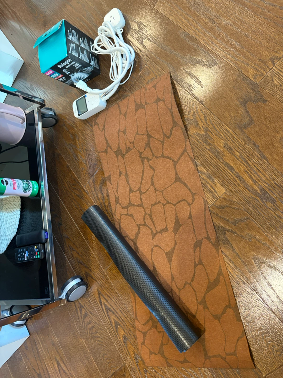 Halogen Heat Lamp Timer with Roll of Brown Patterned Flooring
