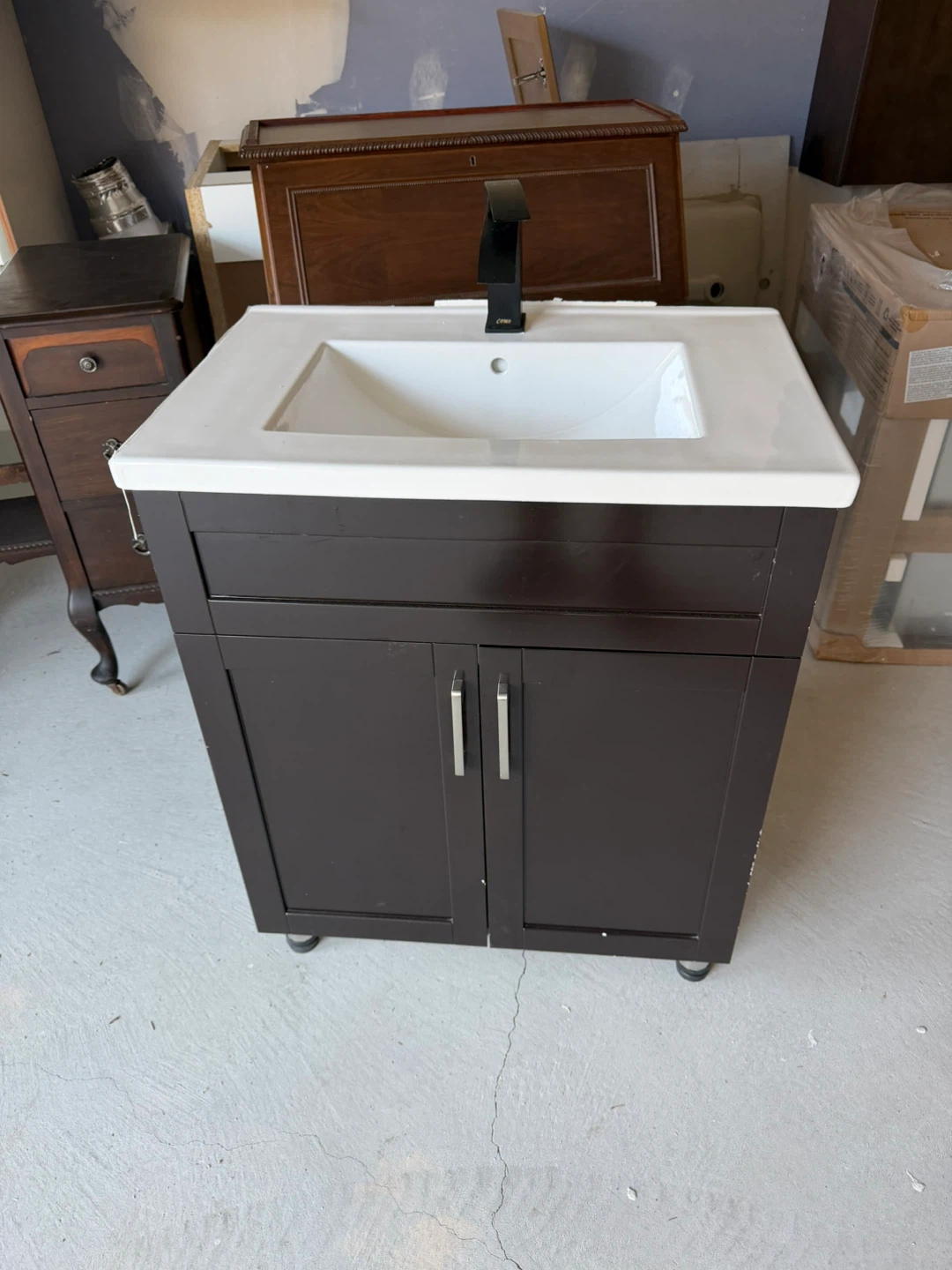Dark Brown Vanity with White Sink and Black Faucet
