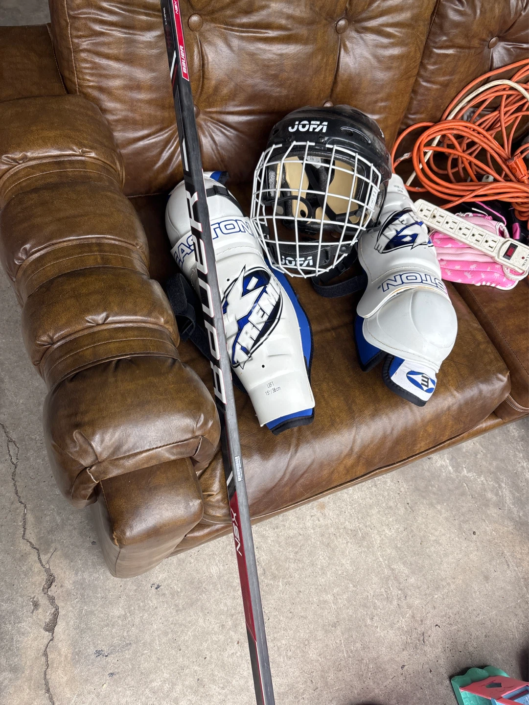 Kids hockey stick and pads and helmet