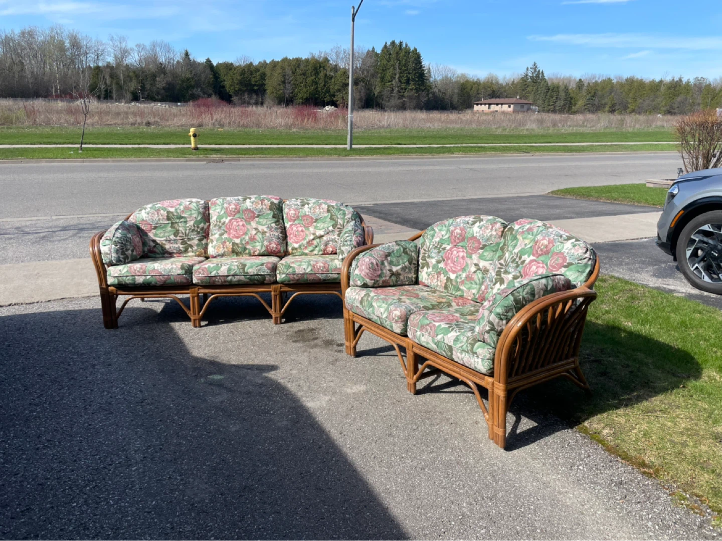 2 Vintage  Rattan Sofas with Floral Cushions