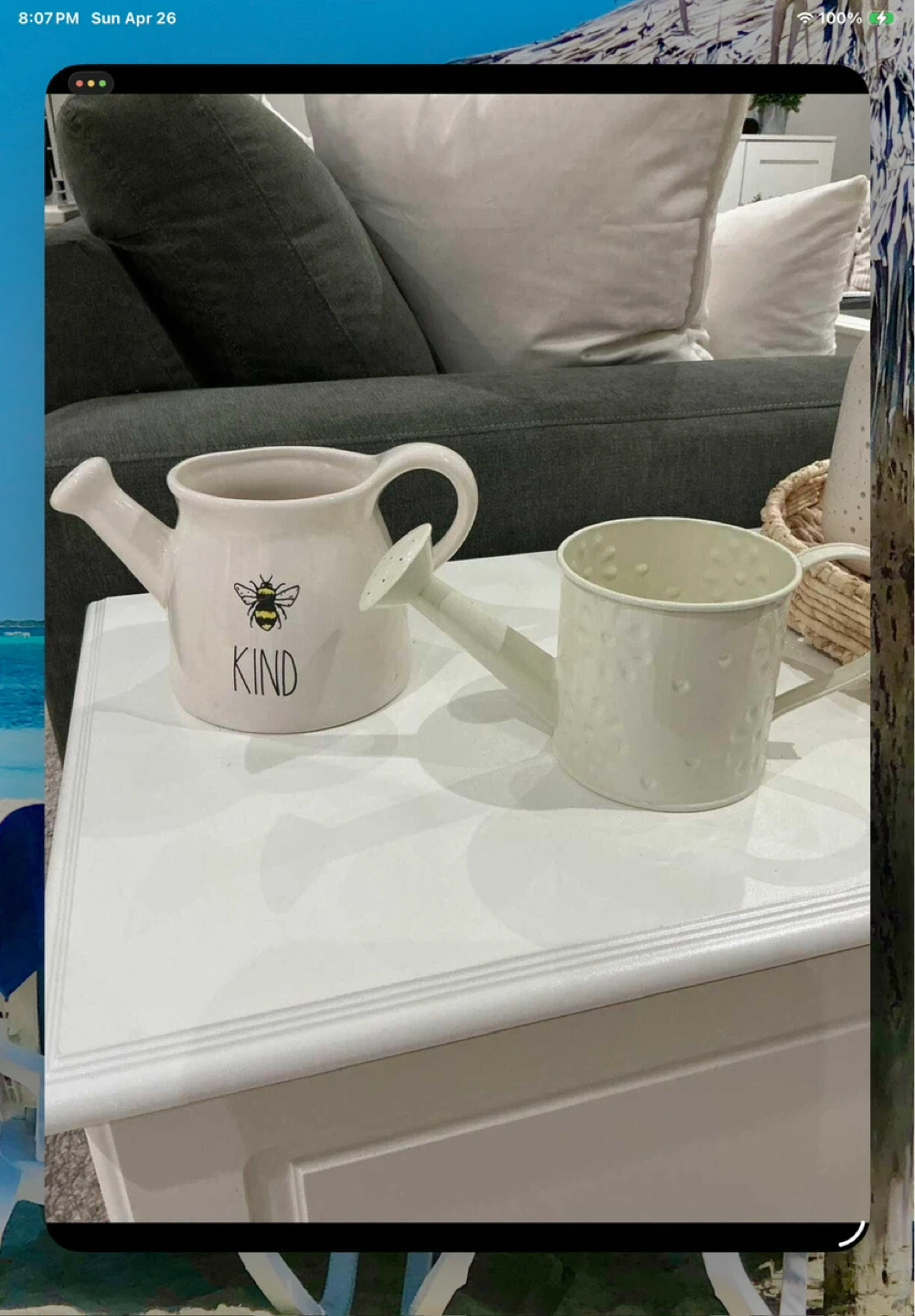 2 watering cans. One is a Rae Dunn "KIND" Bee Watering Can