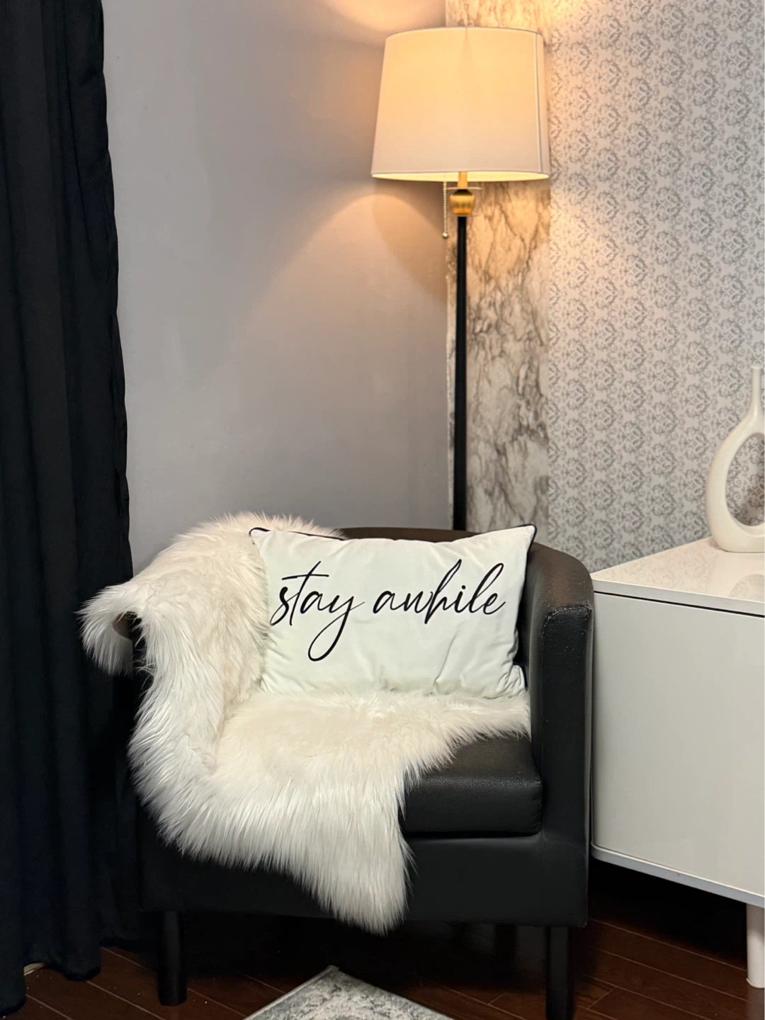 Black Accent Chair with "Stay Awhile" Pillow
