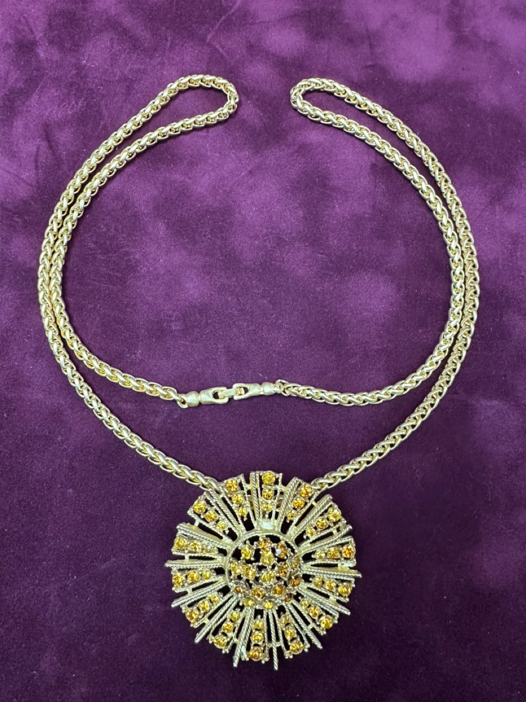 Gold tone sunburst pendant necklace