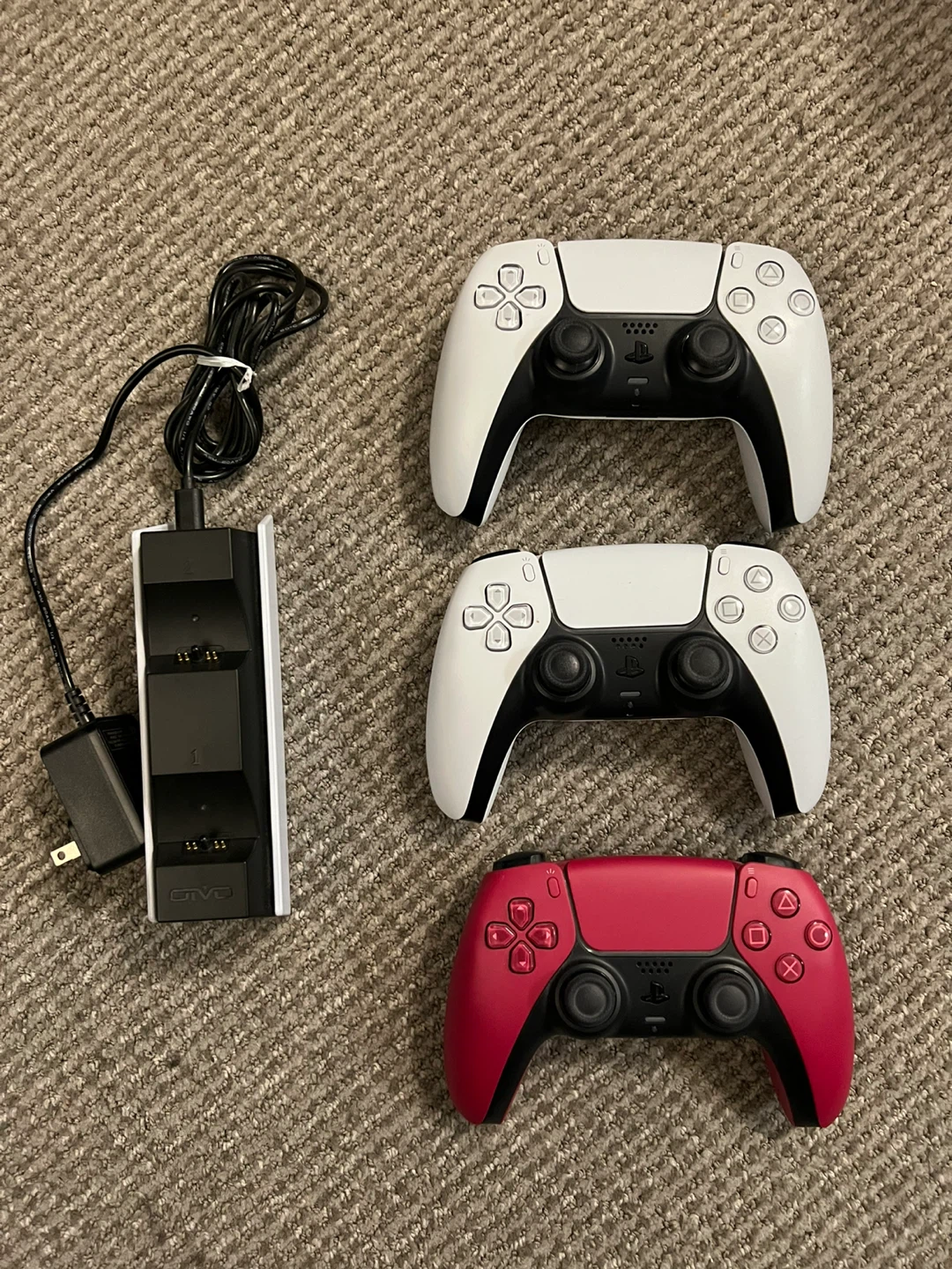 Three PlayStation 5 DualSense Controllers and Charging Station