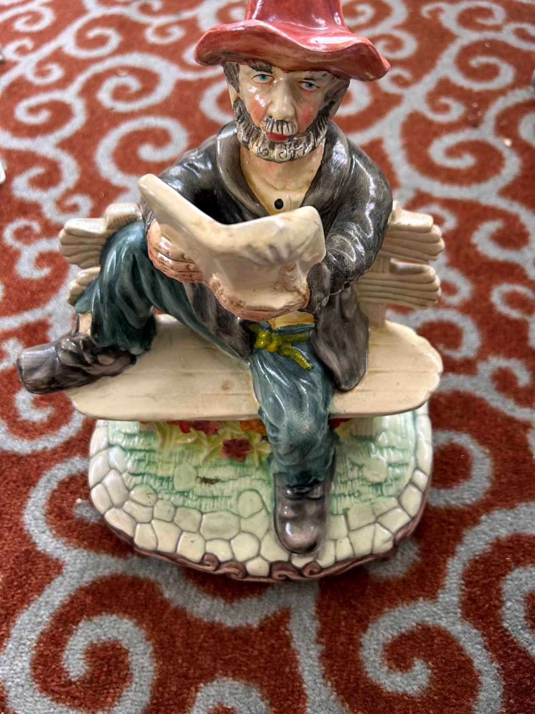 Figurine of a man on a bench