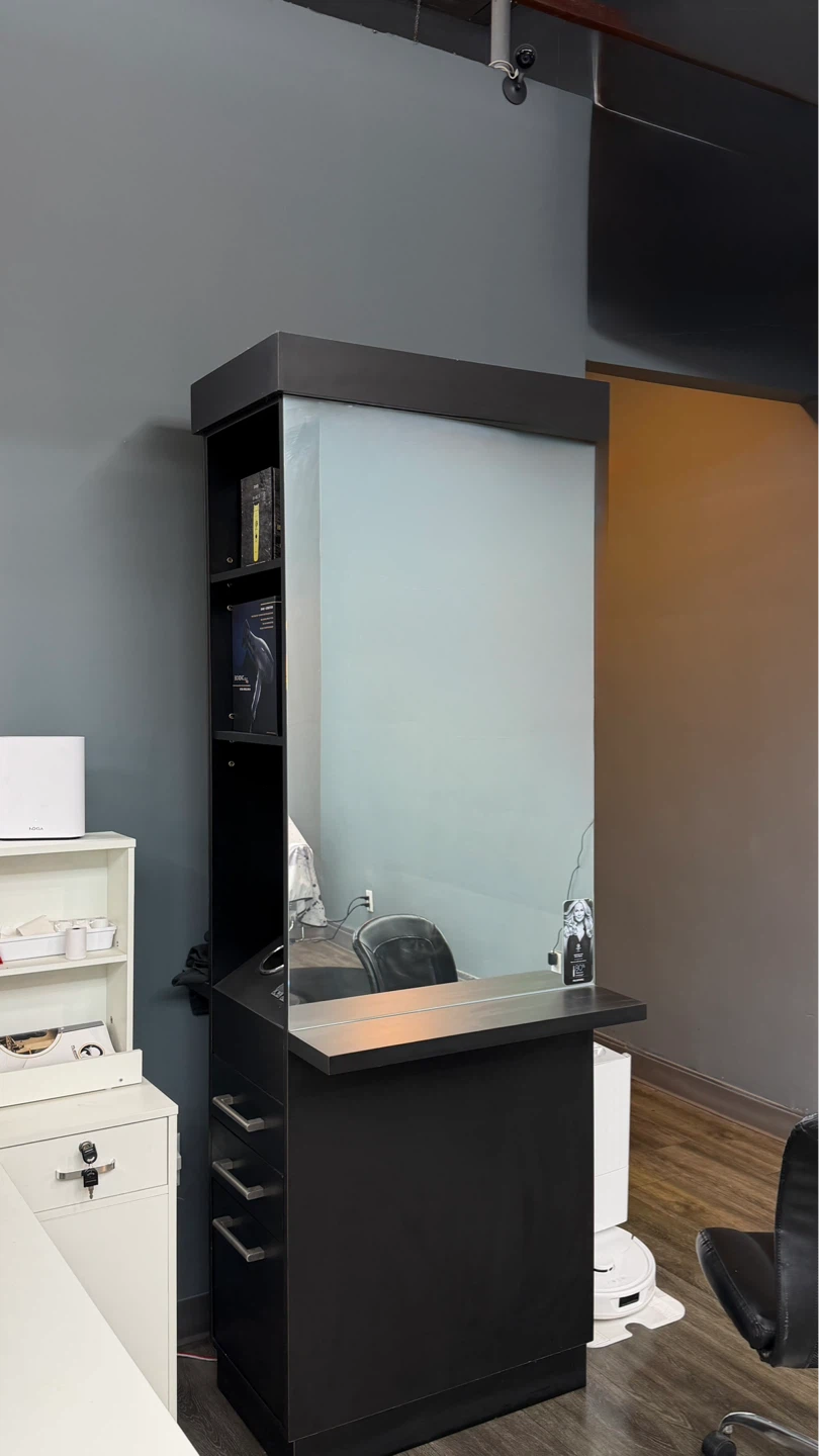 Black salon styling station with mirror and storage
