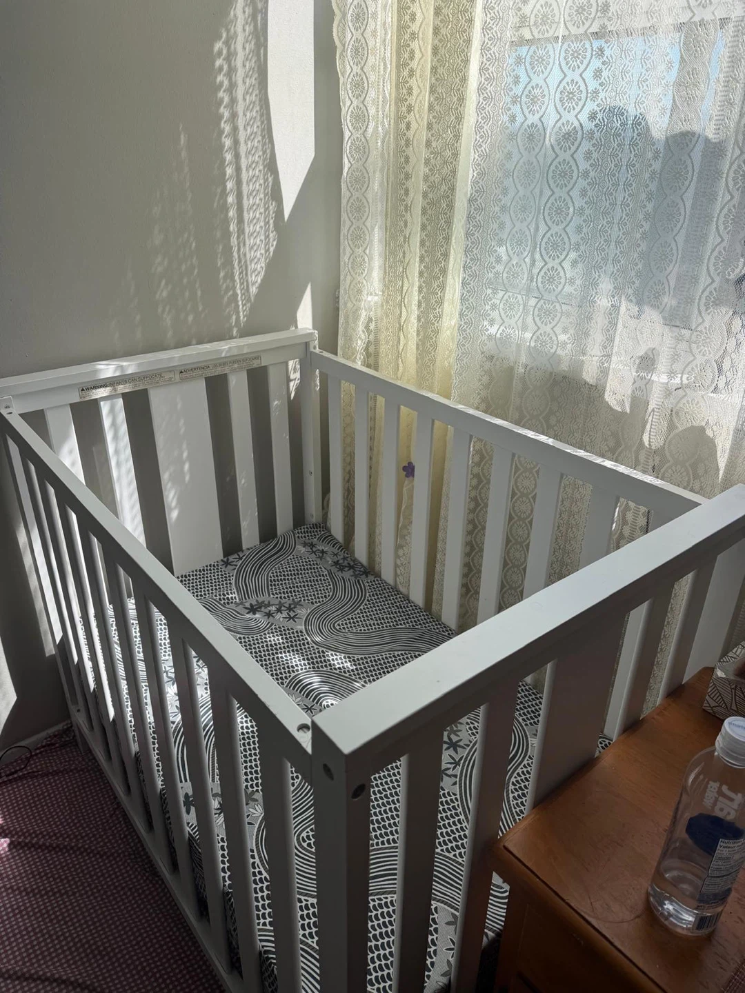 White Baby Crib with Patterned Mattress