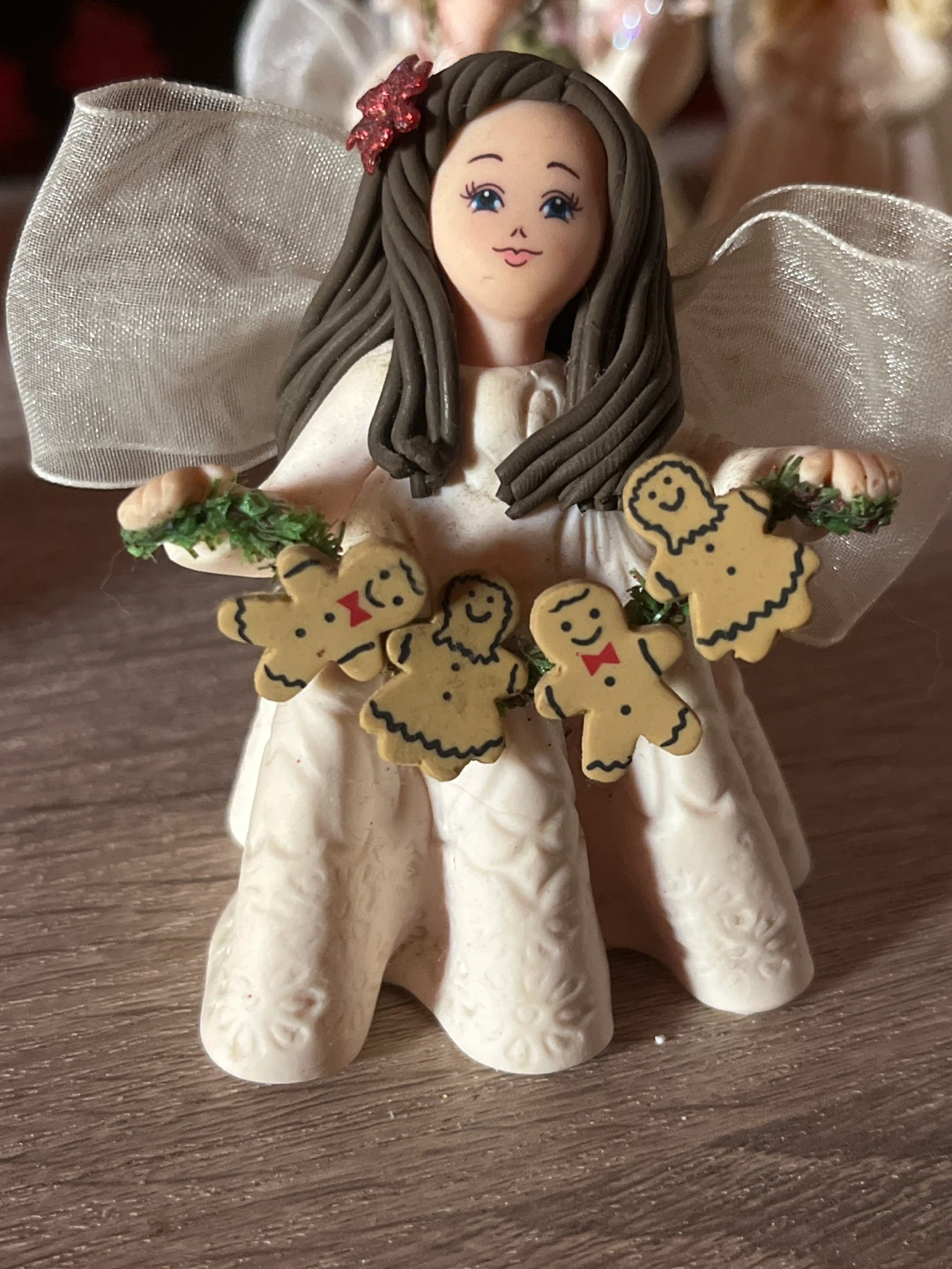Angel holding gingerbread man garland figurine