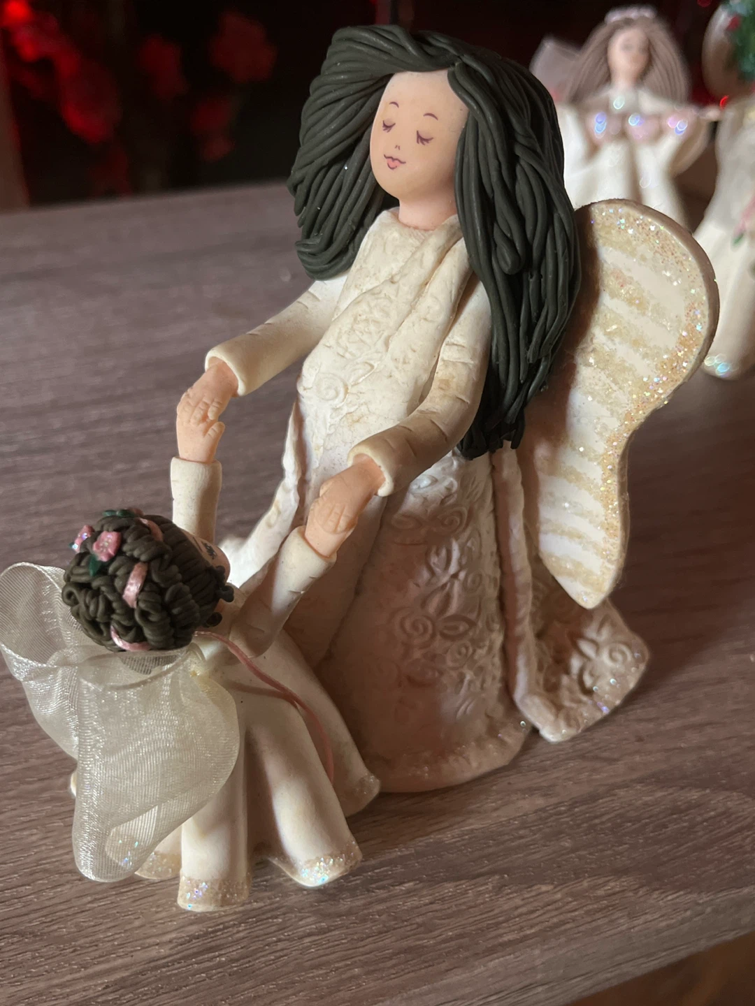 Angel figurine holding hands with child