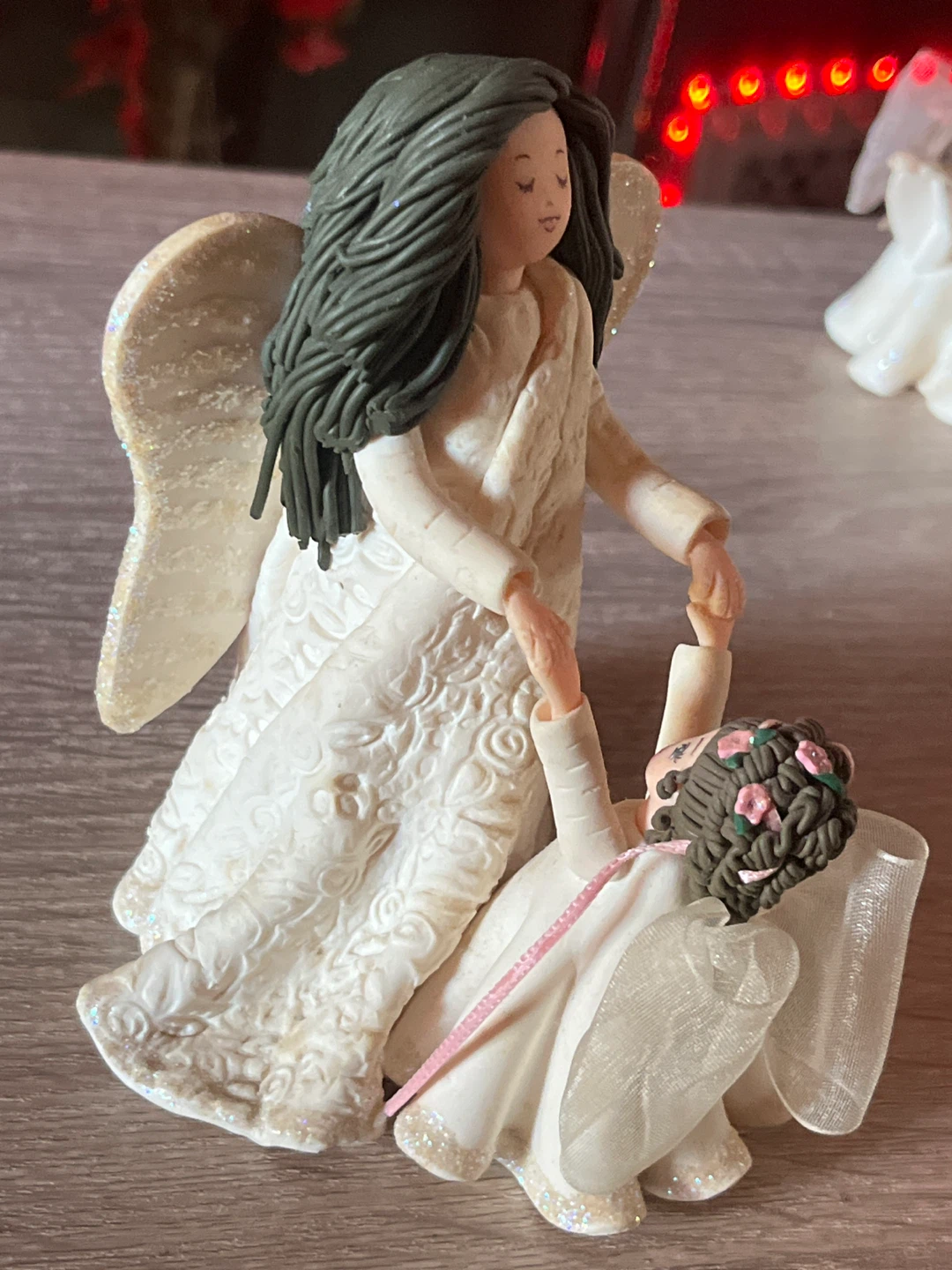 Angel figurine holding hands with child - photo 2