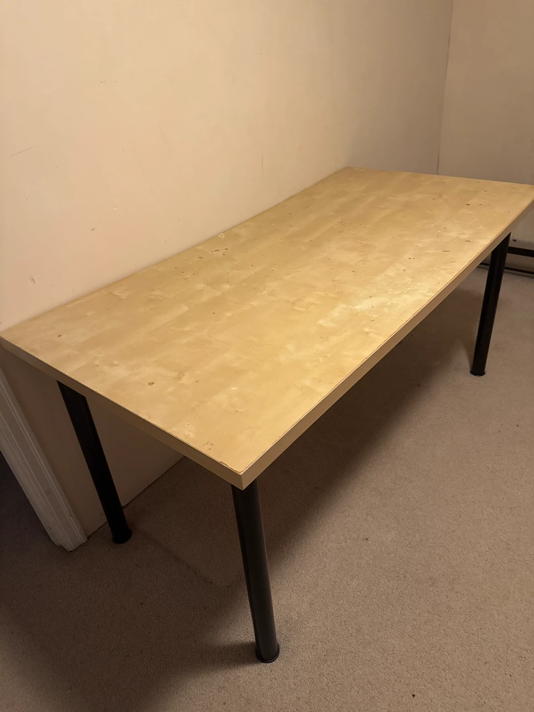 Light wood laminate desk with black metal legs