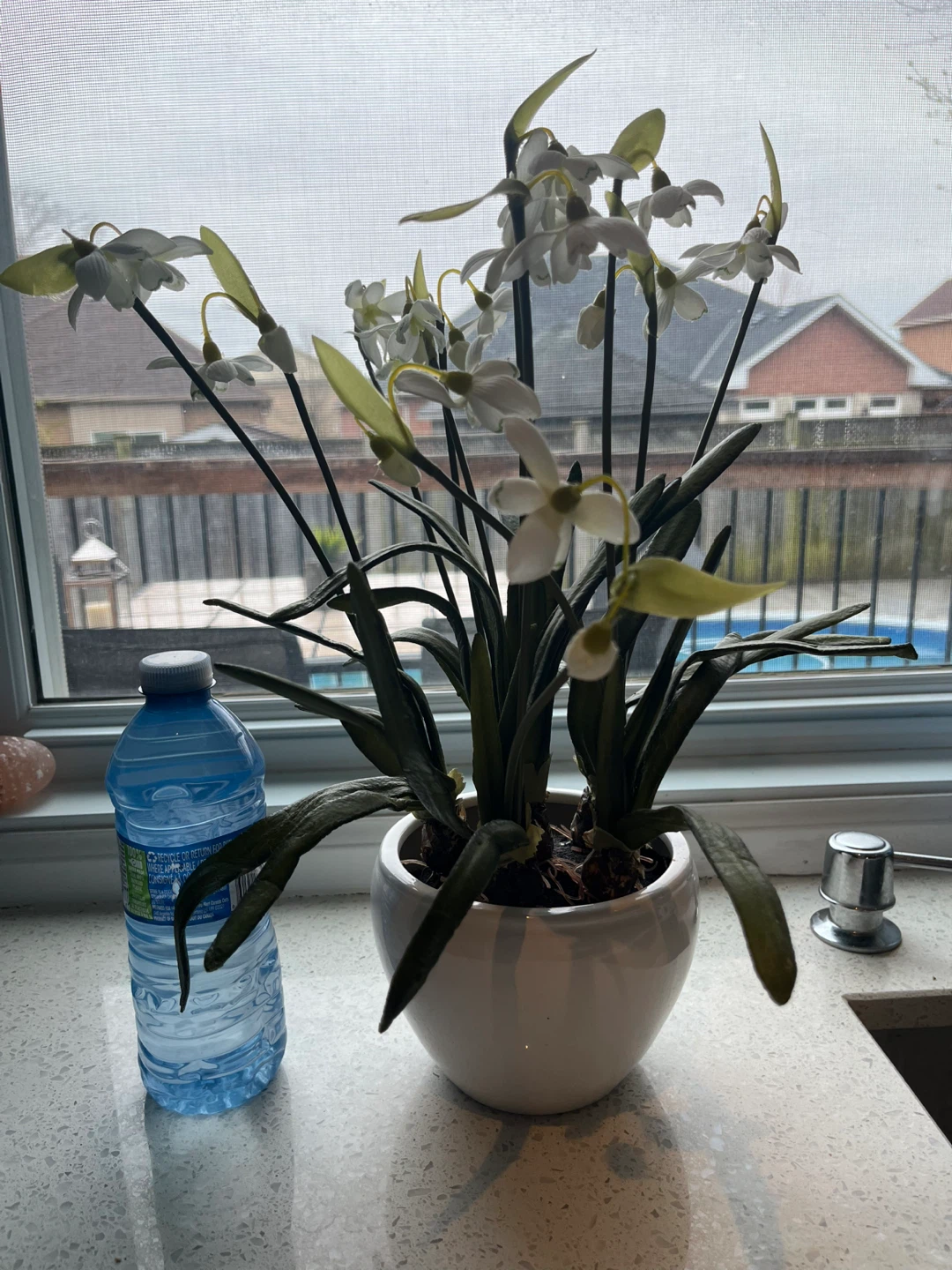 Beautiful faux plant in white ceramic pot