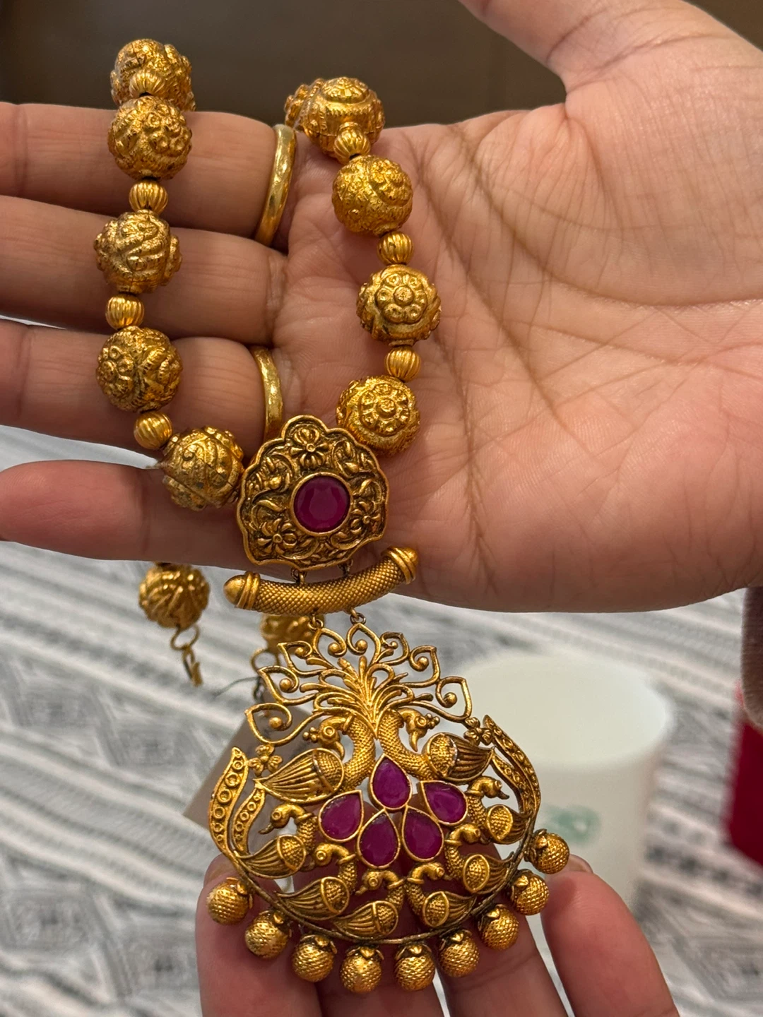 Gold-toned necklace with ruby-coloured stones