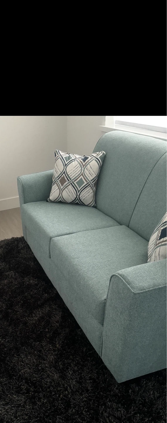 Two-seater sofa in teal