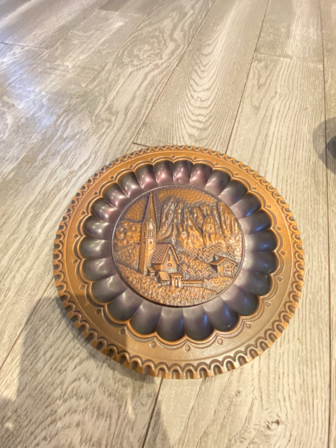 Vintage Embossed Metal Wall Plate with Alpine Village Scene