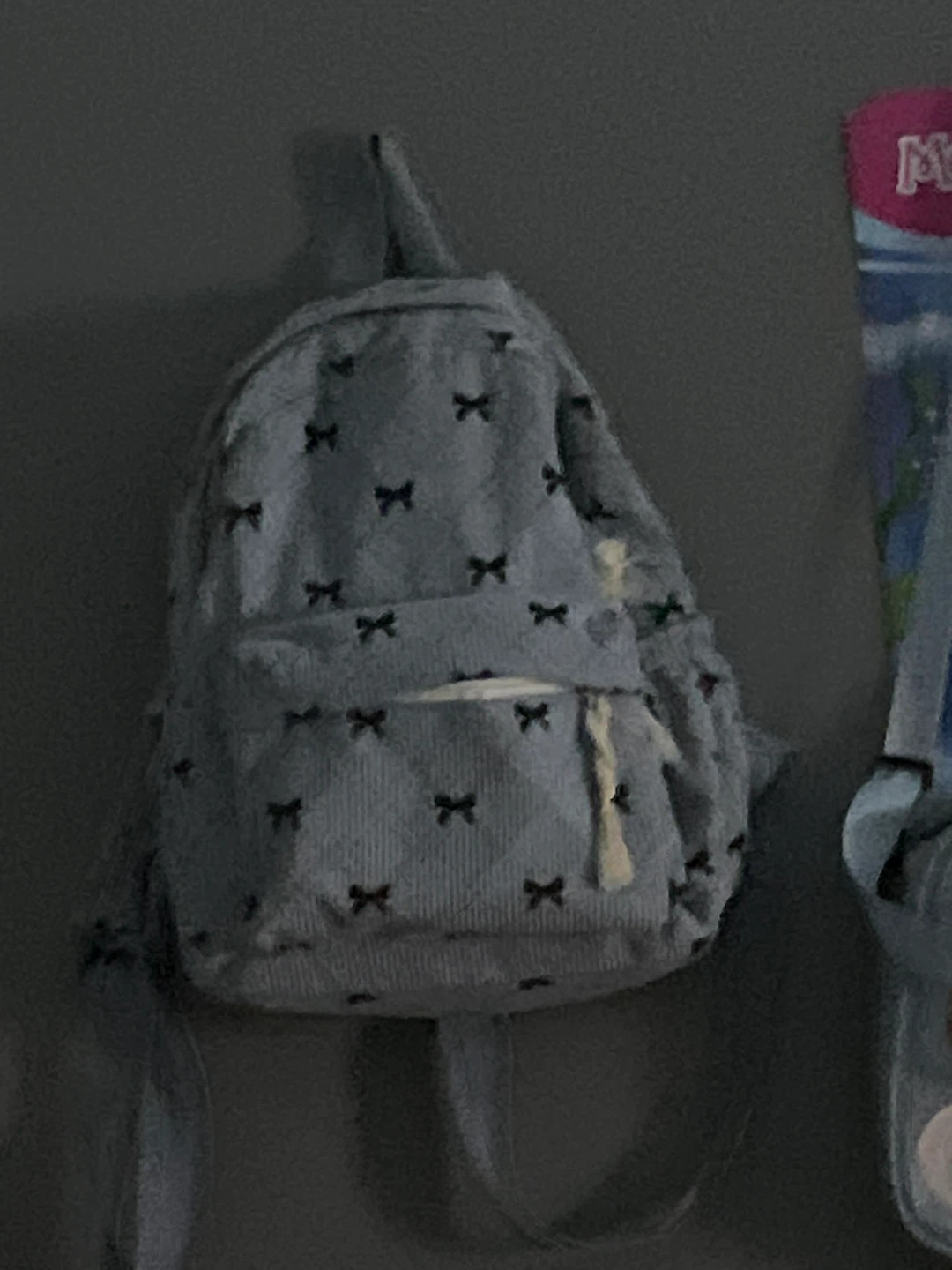 Blue backpack with bow pattern