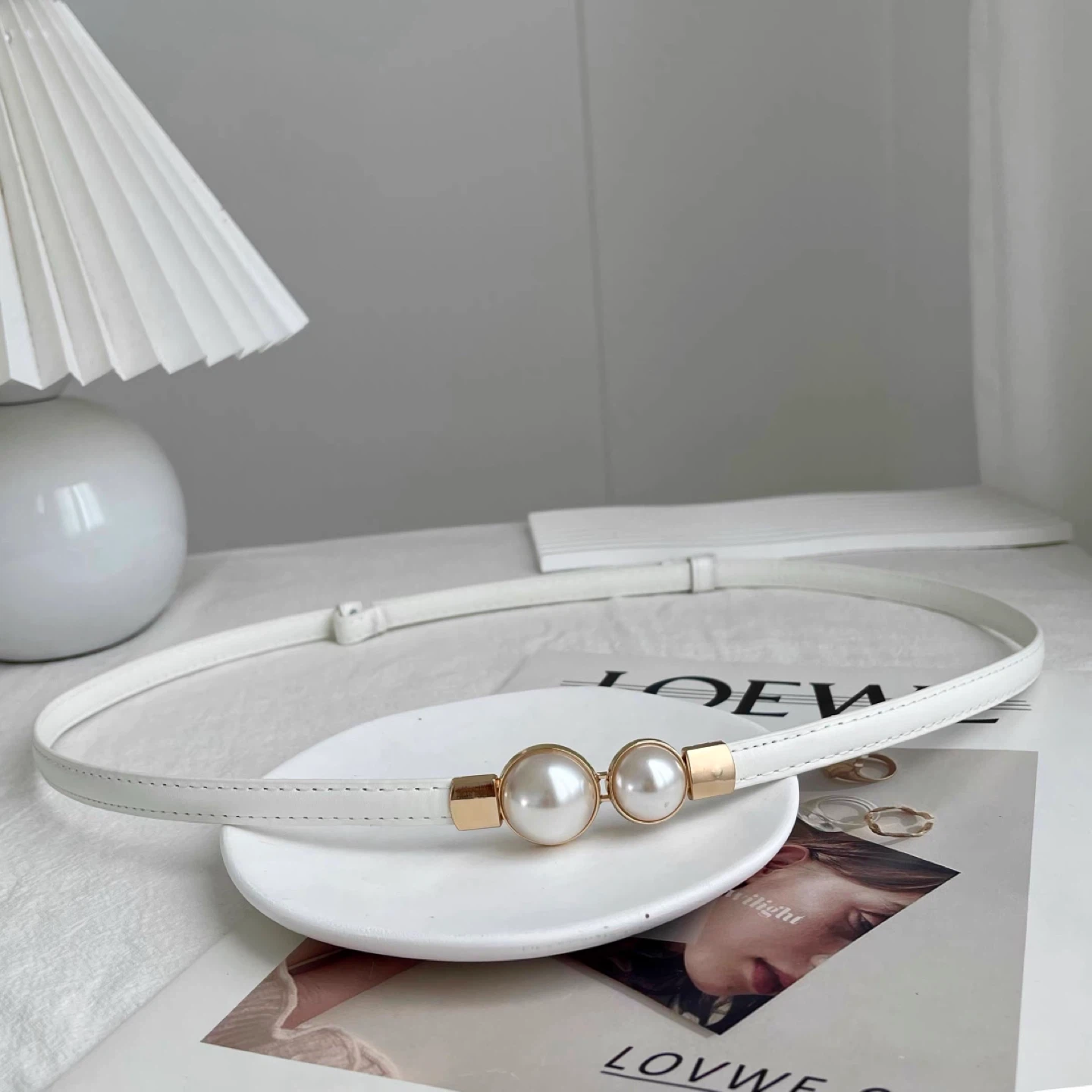 White fashion belt with pearl and gold accent