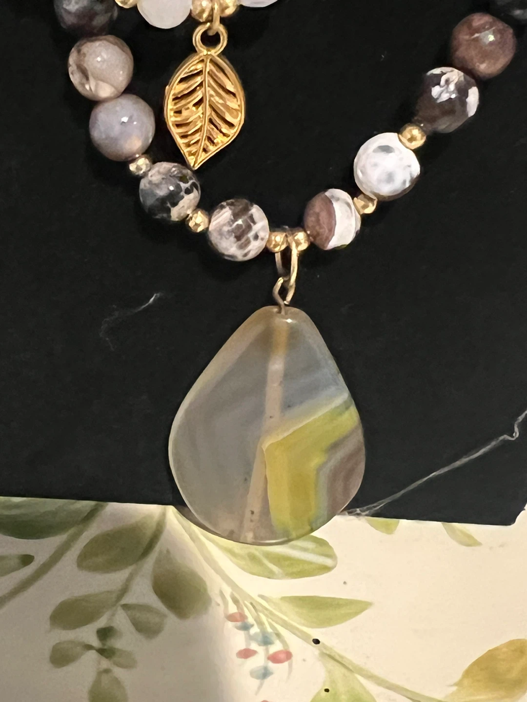 Beaded Necklace with Teardrop Pendant and Leaf Charm