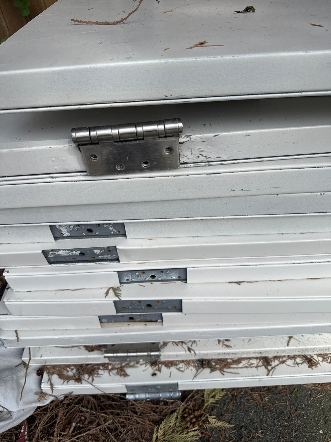 Stack of White Metal Doors with Hinges