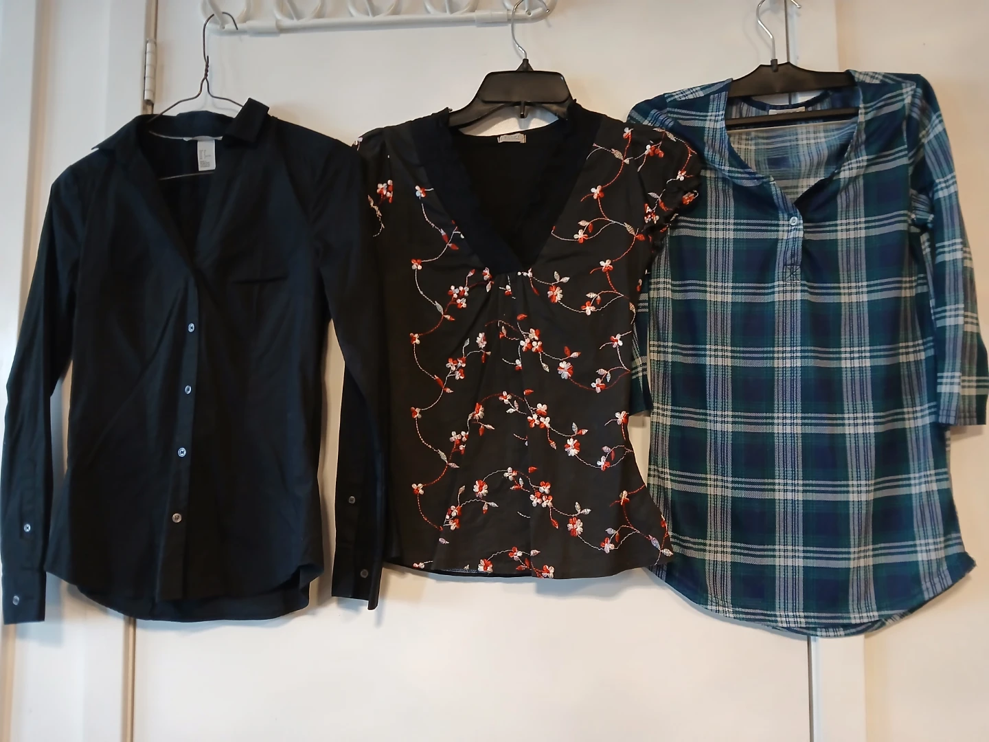 3 Ladies tops: H&M black shirt, floral top & plaid shirt. $4 EA.