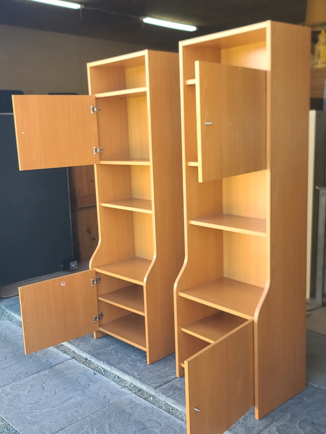 Pair of light wood bookcases with doors and shelves - photo 2