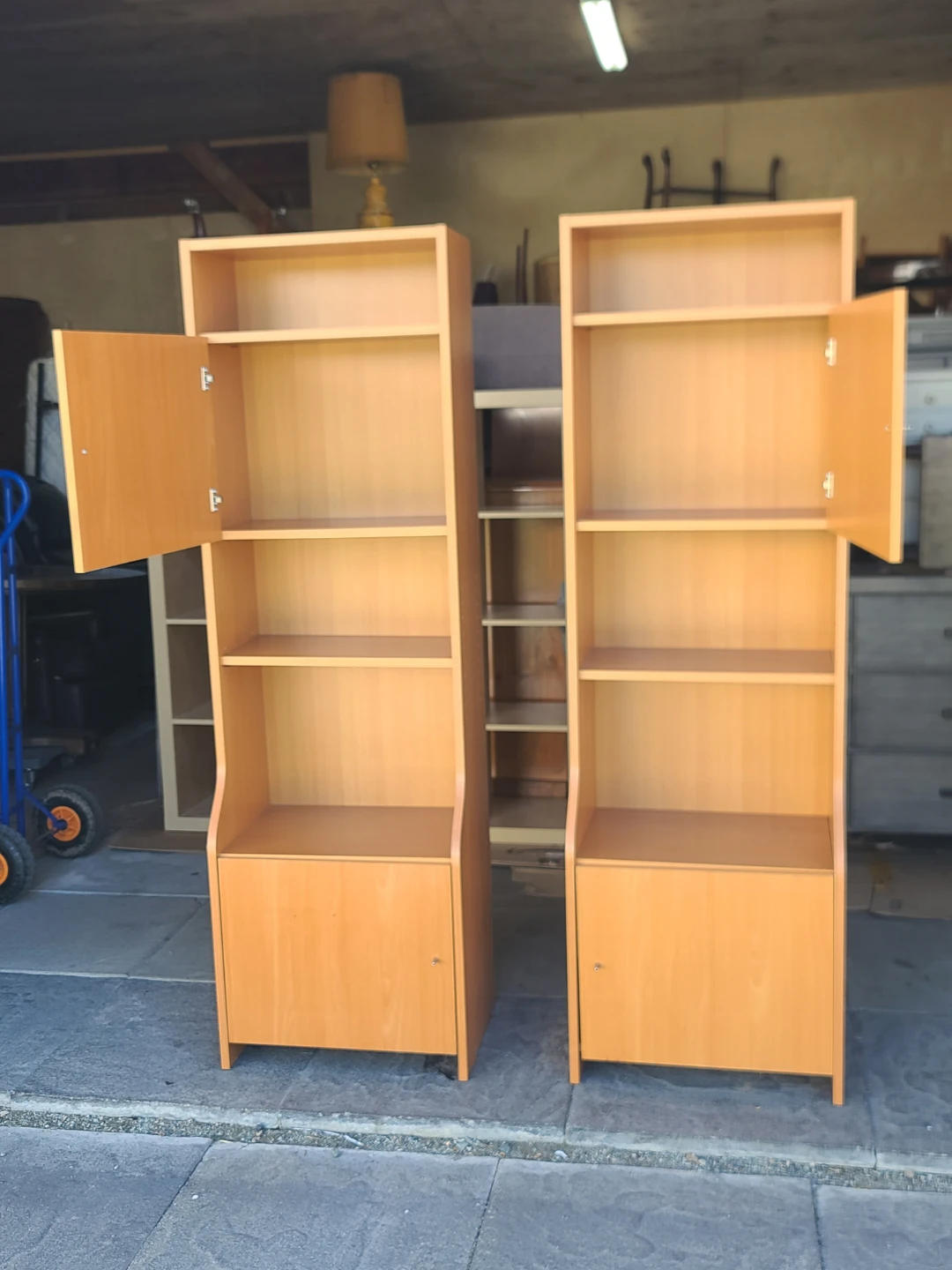 Pair of light wood bookcases with doors and shelves - photo 3
