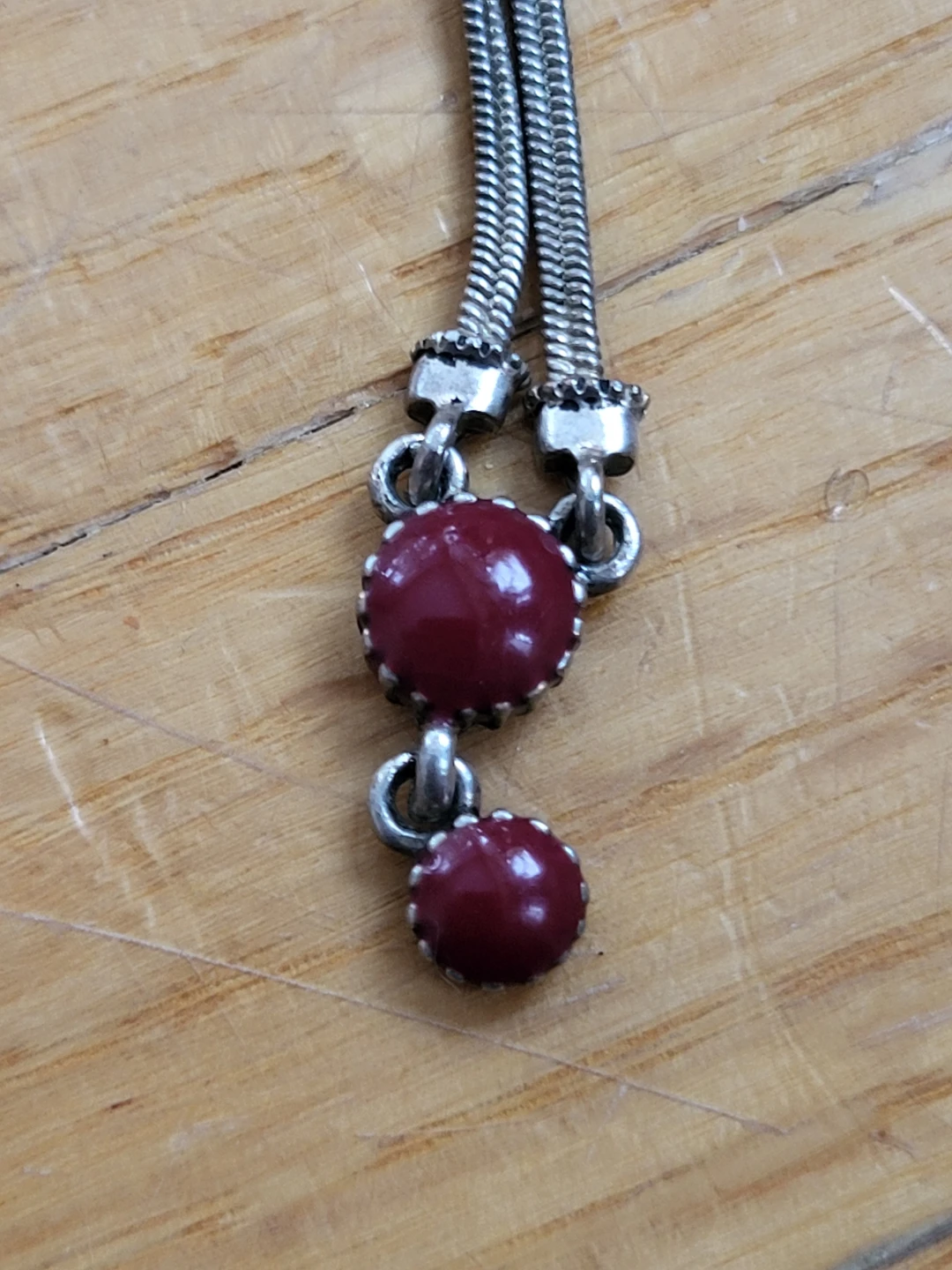 Silver tone necklace with red stones