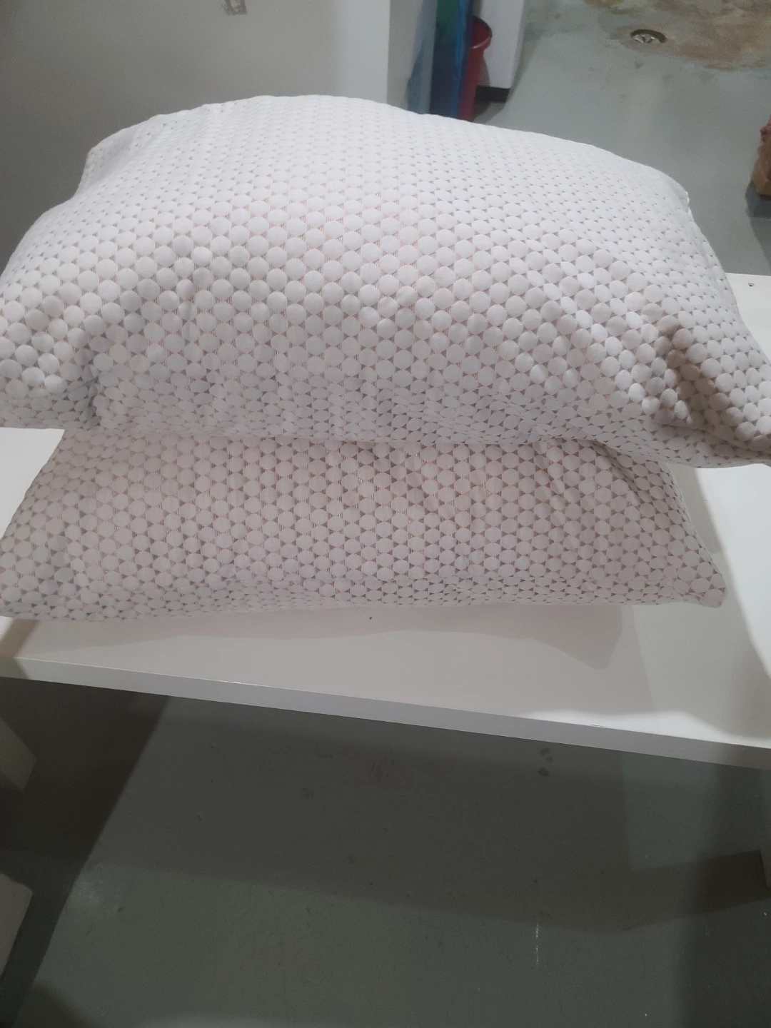 Two white patterned pillows