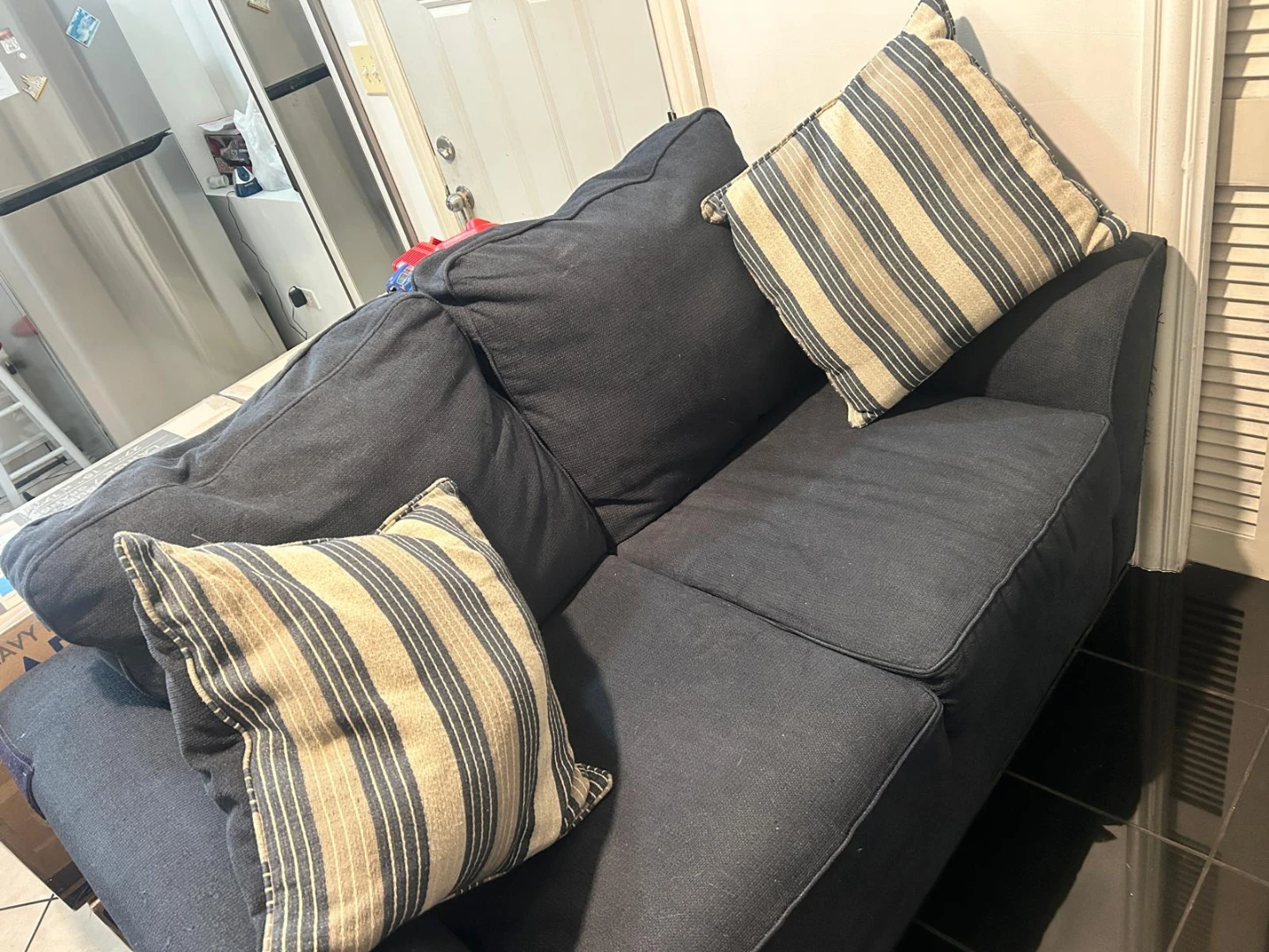 Dark Blue Sectional Couch with Striped Pillows