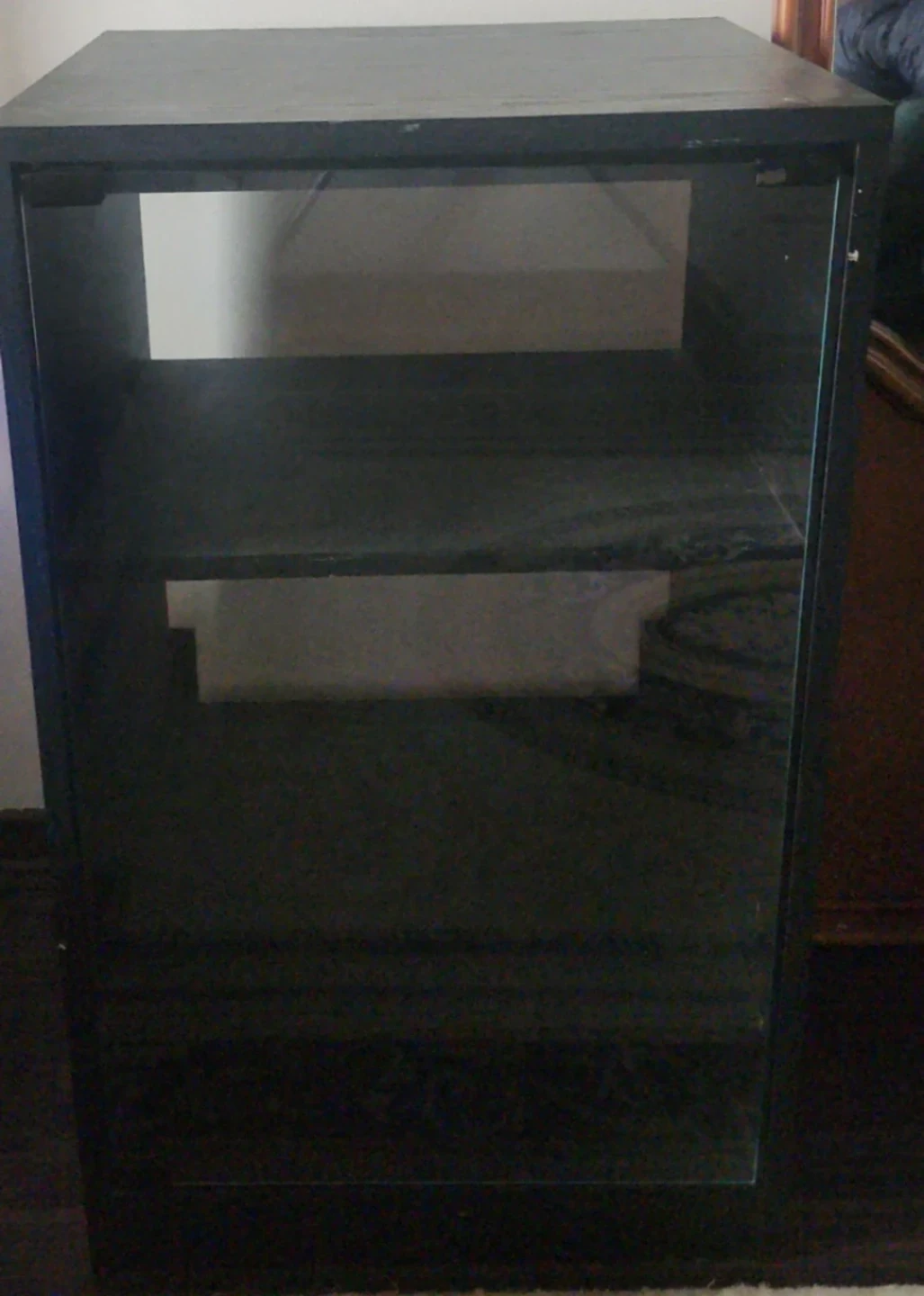 Black media shelf with glass door