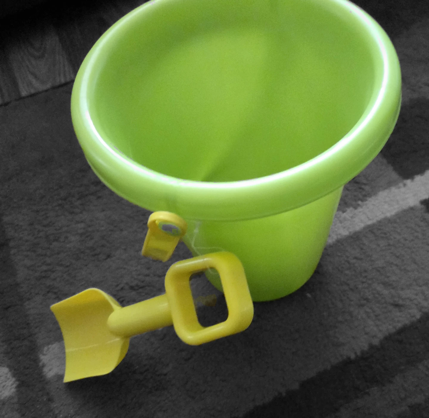 Set of colourful plastic sand buckets, rakes and shovels