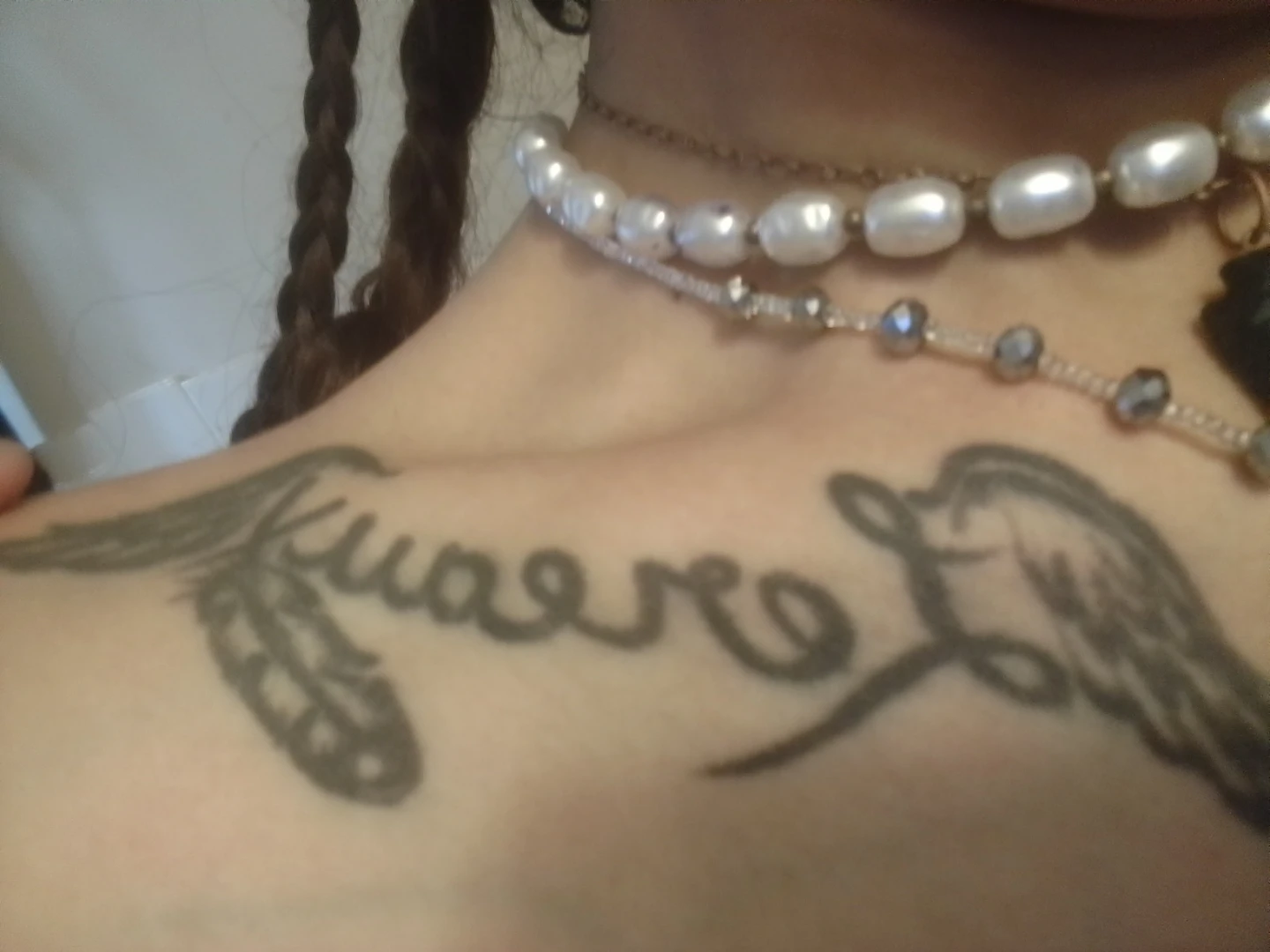 Tattoo with Feather and Wing Design