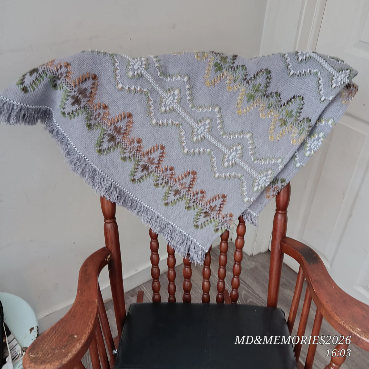 Wooden Rocking Chair with Embroidered Throw