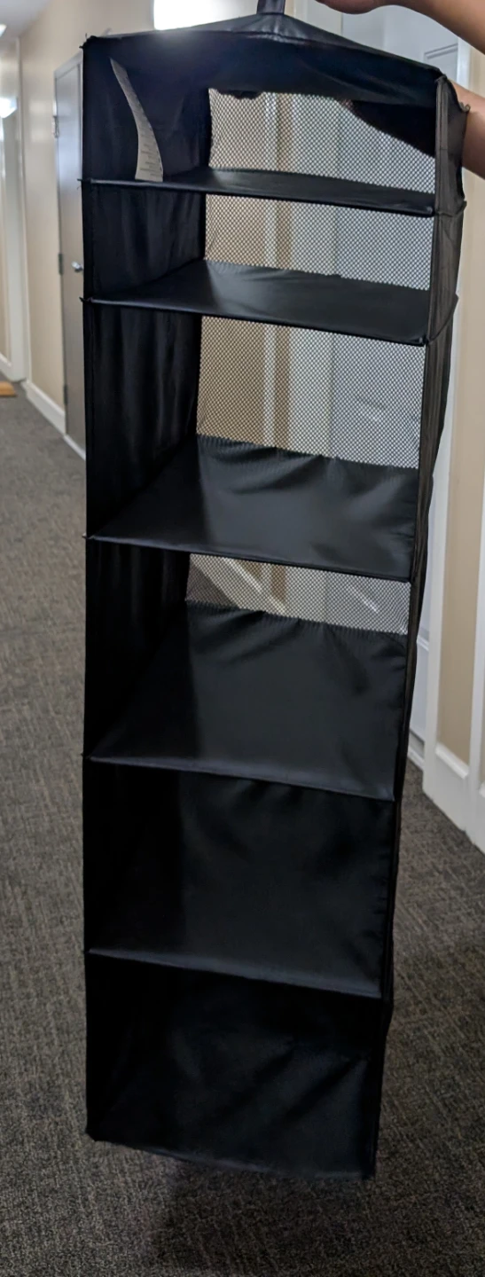 Black hanging closet organizer with 6 shelves
