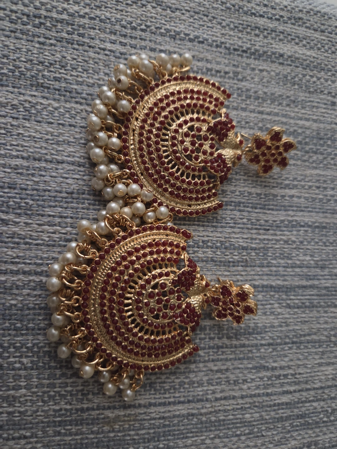 Gold Tone Jhumka Earrings with Red Stones and Pearls